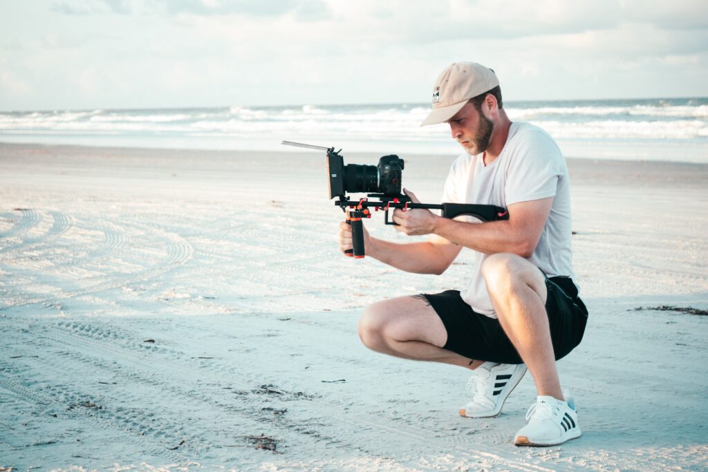 man with camera on beach
